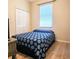 Bedroom with wood floor, large window, blinds, closet, and bed with blue comforter at 2445 Cypress Trace Cir, Orlando, FL 32825