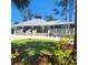 Charming clubhouse with a metal roof, surrounded by lush landscaping and mature trees at 2445 Cypress Trace Cir, Orlando, FL 32825
