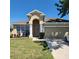 Charming single-Gathering home featuring a well-manicured lawn and attached two-car garage at 2445 Cypress Trace Cir, Orlando, FL 32825