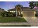 Inviting single-Gathering home featuring a well-manicured lawn, attached two car garage and classic design at 2445 Cypress Trace Cir, Orlando, FL 32825