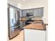 Stylish kitchen featuring gray cabinets, stainless steel appliances, and a granite countertop at 2445 Cypress Trace Cir, Orlando, FL 32825