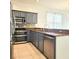 Well-equipped kitchen with stainless steel appliances, granite countertops, and gray cabinetry at 2445 Cypress Trace Cir, Orlando, FL 32825