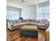 Spacious living room featuring hardwood floors, modern chandelier, and oversized sectional at 2445 Cypress Trace Cir, Orlando, FL 32825