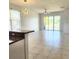 Open living space featuring tile flooring, abundant natural light, and access to outdoor patio at 2445 Cypress Trace Cir, Orlando, FL 32825