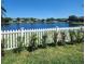 Beautiful backyard with white picket fence looking out over a pond at 2445 Cypress Trace Cir, Orlando, FL 32825