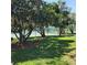 View of community tennis court surrounded by trees and landscaping at 2445 Cypress Trace Cir, Orlando, FL 32825