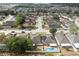 Neighborhood aerial view showcasing backyards with pools, with one home featuring installed solar panels at 252 Elgin Blvd, Davenport, FL 33897