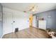Bright bedroom with light wood-look floors, white doors and trim, and light gray accent wall at 252 Elgin Blvd, Davenport, FL 33897