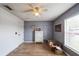 Bedroom featuring light wood-look floors, a ceiling fan, and a white chest of drawers at 252 Elgin Blvd, Davenport, FL 33897