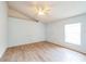 Bright bedroom featuring wood-look tile flooring, ceiling fan, and a large window at 252 Elgin Blvd, Davenport, FL 33897