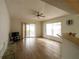 Bright and open living room with sliding glass doors, tile flooring, and a ceiling fan, offering a relaxed space at 252 Elgin Blvd, Davenport, FL 33897