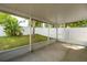 Covered patio provides a relaxing outdoor space with views of the lush, fenced backyard and is ideal for entertaining at 252 Elgin Blvd, Davenport, FL 33897