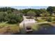 Aerial view of the lake community beach and gazebo covered pier with calm waters at 2532 Waterview Pl, Windermere, FL 34786