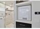 Contemporary bathroom showcasing the walk-in shower and stacked washer and dryer at 2532 Waterview Pl, Windermere, FL 34786