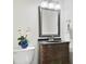 A quaint bathroom with a stylish vanity, sink and toilet, accented by decorative mirror and lighting at 2532 Waterview Pl, Windermere, FL 34786