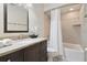 Tiled bathroom with a dark wood vanity, sink, toilet, and tiled tub/shower combo at 2532 Waterview Pl, Windermere, FL 34786