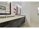 Modern bathroom with double sink vanity, stylish mirrors, and mosaic tile accents at 2532 Waterview Pl, Windermere, FL 34786