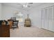Cozy carpeted bedroom with a desk, chair, ceiling fan and closet for work or relaxation at 2532 Waterview Pl, Windermere, FL 34786