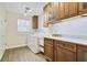 Convenient laundry room with wood-look tile, washer, dryer, sink, and ample cabinet space at 2532 Waterview Pl, Windermere, FL 34786