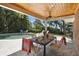 Covered patio with dining table, overlooking the pool and backyard at 2532 Waterview Pl, Windermere, FL 34786