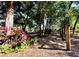Secluded playground with swings and equipment framed by mature trees and lush landscaping, creating a nature-filled play space at 2532 Waterview Pl, Windermere, FL 34786