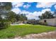 Sprawling backyard with refreshing pool, grassy area, and shade trees, perfect for outdoor enjoyment at 2609 Chinook Trl, Maitland, FL 32751