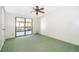 Bright bedroom featuring green carpet and lots of natural light from sliding glass doors at 2609 Chinook Trl, Maitland, FL 32751