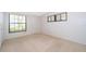 Empty bedroom features neutral carpeting, two windows with natural light, and white walls at 2609 Chinook Trl, Maitland, FL 32751