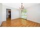 Inviting dining area featuring hardwood floors, a modern chandelier, and a large window at 2609 Chinook Trl, Maitland, FL 32751