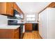 Kitchen features wooden cabinetry, black appliances, and laminate countertops at 2609 Chinook Trl, Maitland, FL 32751