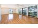 Expansive living room featuring gleaming hardwood floors and large windows offering serene outdoor views at 2609 Chinook Trl, Maitland, FL 32751