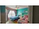 Bright bedroom featuring twin beds, a nightstand, and colorful decor at 2618 Lodi Cir # 102, Kissimmee, FL 34746