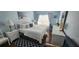 Serene bedroom featuring soft blue walls, a plush white bed, and bright natural light at 2618 Lodi Cir # 102, Kissimmee, FL 34746