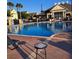 Community swimming pool with ample lounge seating and clubhouse in the background at 2618 Lodi Cir # 102, Kissimmee, FL 34746