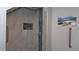 Modern shower with marble-look tile, glass door, and built-in niche for storage at 2618 Lodi Cir # 102, Kissimmee, FL 34746