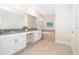 Spacious bathroom featuring double vanities, large mirror, and a soaking tub at 2771 Oxymoron Way, Kissimmee, FL 34746