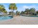 Beautiful community pool area with palm trees and a lazy river, perfect for relaxing on a sunny day at 2771 Oxymoron Way, Kissimmee, FL 34746