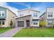 Charming two-story home with stone accents, landscaped yard, and modern design at 2771 Oxymoron Way, Kissimmee, FL 34746