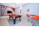 Inviting game room boasting a pool table, comfortable seating, and colorful wall art at 2771 Oxymoron Way, Kissimmee, FL 34746