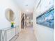 Inviting hallway with sleek tile flooring, modern decor, and staircase access at 2771 Oxymoron Way, Kissimmee, FL 34746