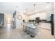 Modern kitchen features white cabinetry, stainless appliances, and a breakfast bar with seating at 2771 Oxymoron Way, Kissimmee, FL 34746