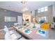 Open-concept living and dining area with bright decor and access to a screened patio at 2771 Oxymoron Way, Kissimmee, FL 34746