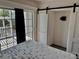 Bright bedroom features slider doors leading to deck and closet with sliding barn doors at 3067 Ne 102Nd Avenue Rd, Silver Springs, FL 34488