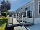 Exterior featuring a charming deck with black and white railings, perfect for outdoor entertaining at 3067 Ne 102Nd Avenue Rd, Silver Springs, FL 34488