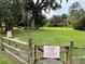 Enclosed dog run with manicured lawn, secure fencing, and posted rules for responsible pet owners at 3067 Ne 102Nd Avenue Rd, Silver Springs, FL 34488