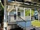Well-maintained home featuring a lovely front porch, accessible steps, and a stylish outdoor living space at 3067 Ne 102Nd Avenue Rd, Silver Springs, FL 34488