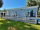 Exterior view showcasing a deck with white railings, great for relaxing and enjoying the outdoors at 3067 Ne 102Nd Avenue Rd, Silver Springs, FL 34488