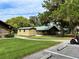 Charming log cabins with green roofs nestled in a lush, green landscape, creating a serene retreat at 3067 Ne 102Nd Avenue Rd, Silver Springs, FL 34488