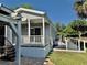 Charming home featuring a spacious deck, white railings and stairs leading to a welcoming front porch at 3067 Ne 102Nd Avenue Rd, Silver Springs, FL 34488