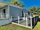 A single-Gathering home featuring a deck and black railings, adding to the home's charm and appeal at 3067 Ne 102Nd Avenue Rd, Silver Springs, FL 34488